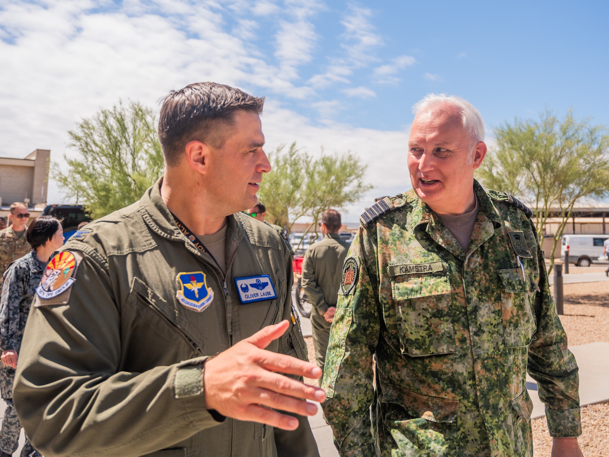 U.S. Air Force Col. Oliver Lause (Left), 56th Operations Group commander, speaks with Royal Netherlands Air Force Col. Berend Kamstra (right), RNLAF military air and space attaché and assistant defense attaché, during a base visit, June 2, 2025, at Luke Air Force Base, Arizona. While at Luke, the delegation received a wing mission brief, participated in a roundtable discussion with Brig. Gen. Berkland, toured two fighter squadrons, experienced F-35 tabletop simulators, visited an F-35 aircraft, and walked the flight line. (U.S. Air Force photo by Senior Airman Elias Carrero)
