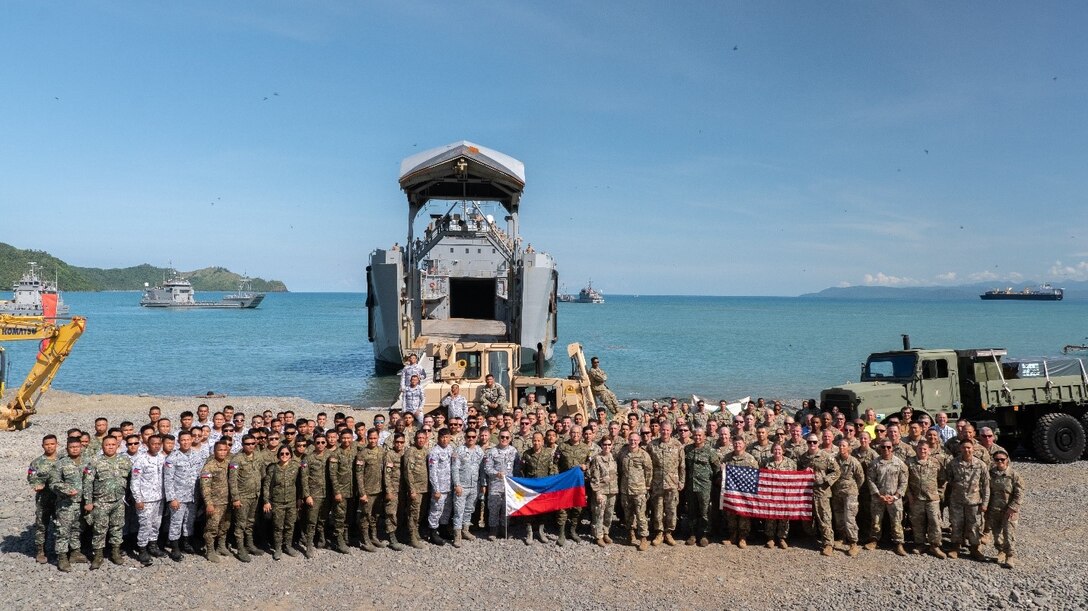 Participants pose for a group picture during joint exercise Balikatan 25 in Dingalan, Philippines. U.S. Army Engineer Research and Development Center (ERDC) researchers Dr. Tim Rushing, Zach Tyler, Mason Anglin, and Staley Boc (not pictured) supported beach landing operations with in-person engineering and technical guidance of the ERDC’s Submersible Matting system during this year’s exercise. (U.S. Marine Corps photo by Cpl. Brian Knowles)