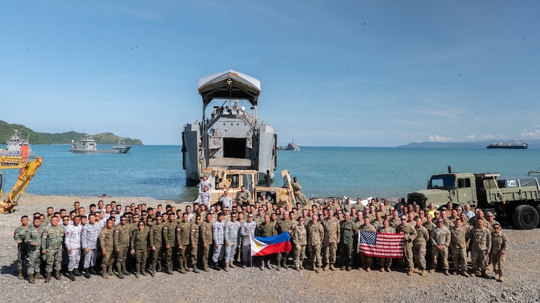 Participants pose for a group picture during joint exercise Balikatan 25 in Dingalan, Philippines. U.S. Army Engineer Research and Development Center (ERDC) researchers Dr. Tim Rushing, Zach Tyler, Mason Anglin, and Staley Boc (not pictured) supported beach landing operations with in-person engineering and technical guidance of the ERDC’s Submersible Matting system during this year’s exercise. (U.S. Marine Corps photo by Cpl. Brian Knowles)