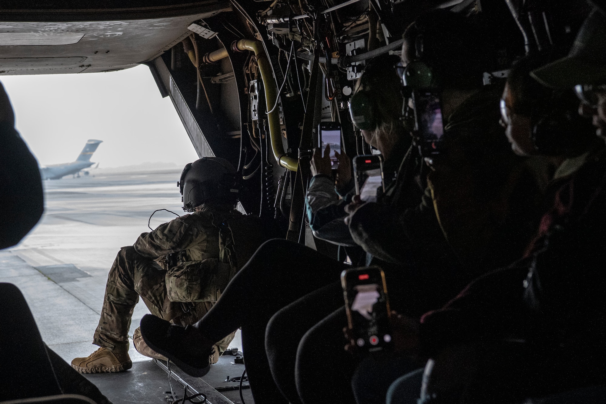 An Airman assigned to the 353rd Special Operations Wing sits on the ramp of a CV-22 Osprey.