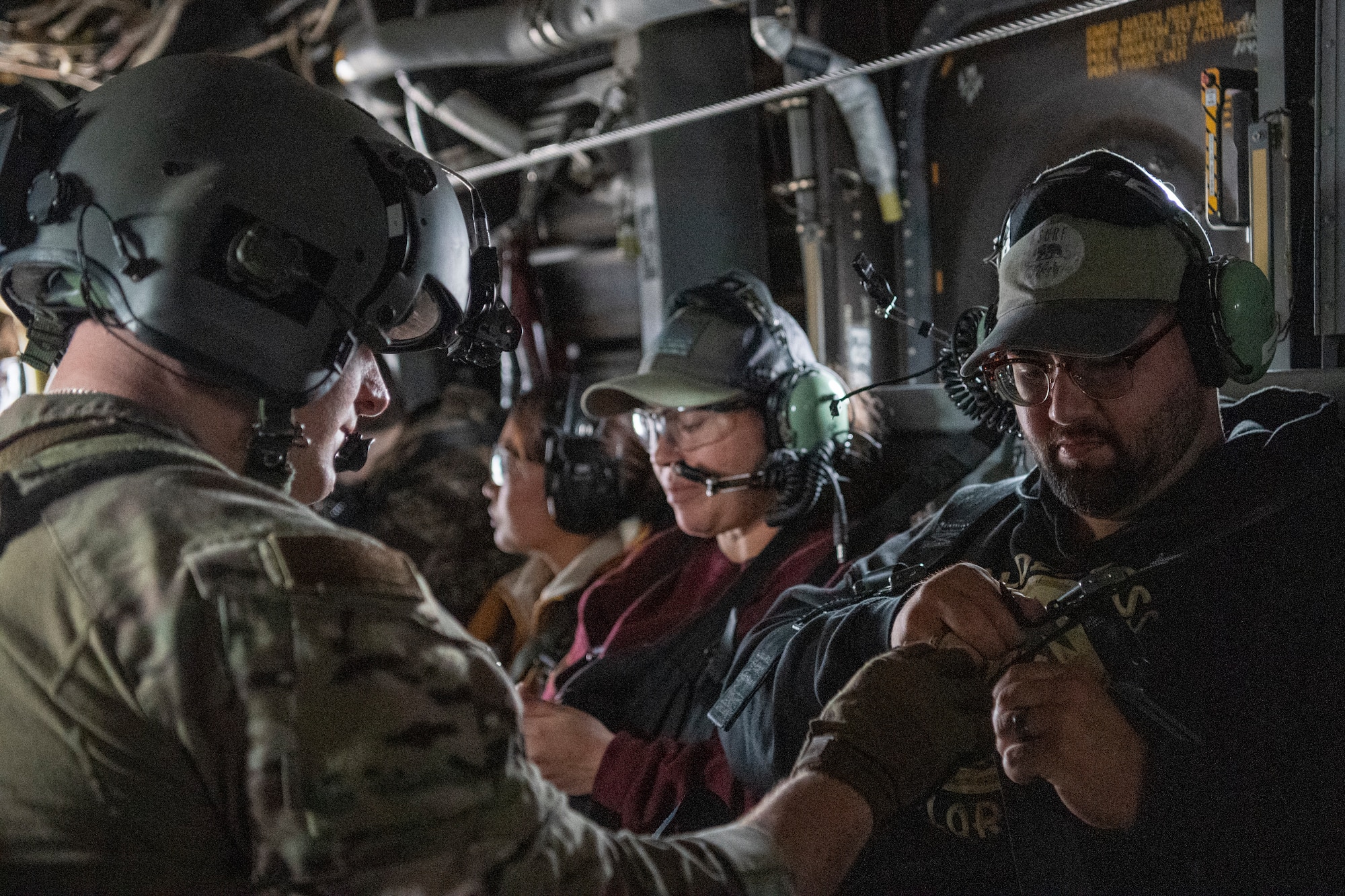 An Airman assigned to the 353rd Special Operations Wing helps a military spouse prepare for an incentive flight