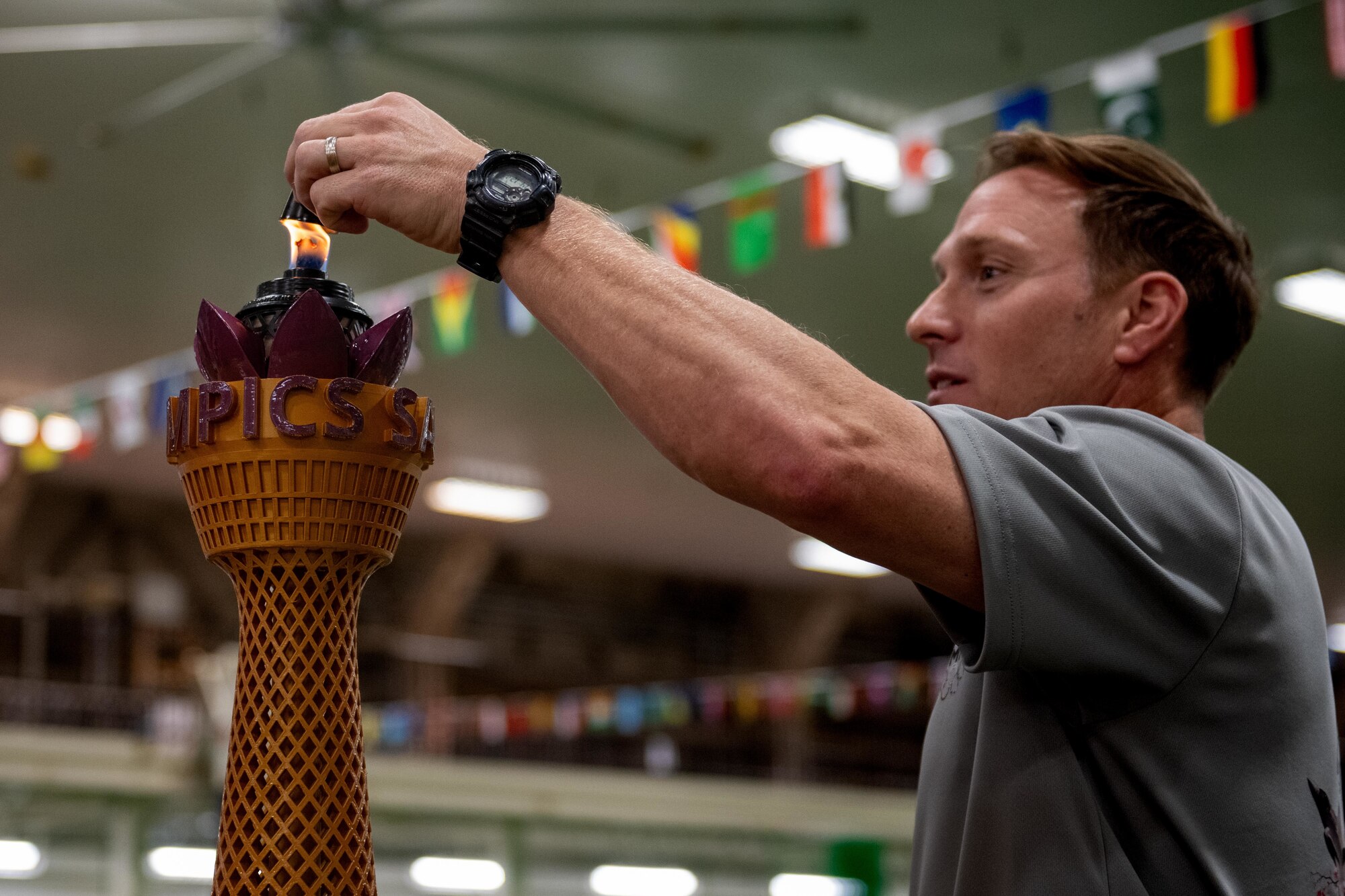 U.S. Air Force Col. Paul Davidson, 35th Fighter Wing base commander, extinguishes a ceremonial flame for the Sakura Olympics 2025 closing ceremony.