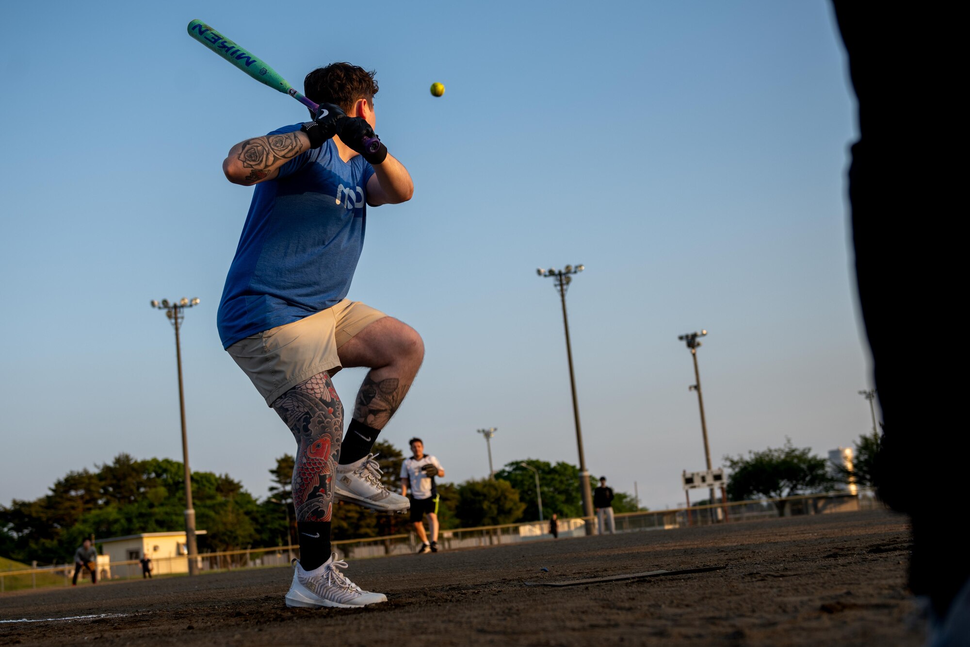 A participant of Sakura Olympics 2025 prepares to bat the ball in a game of softball.