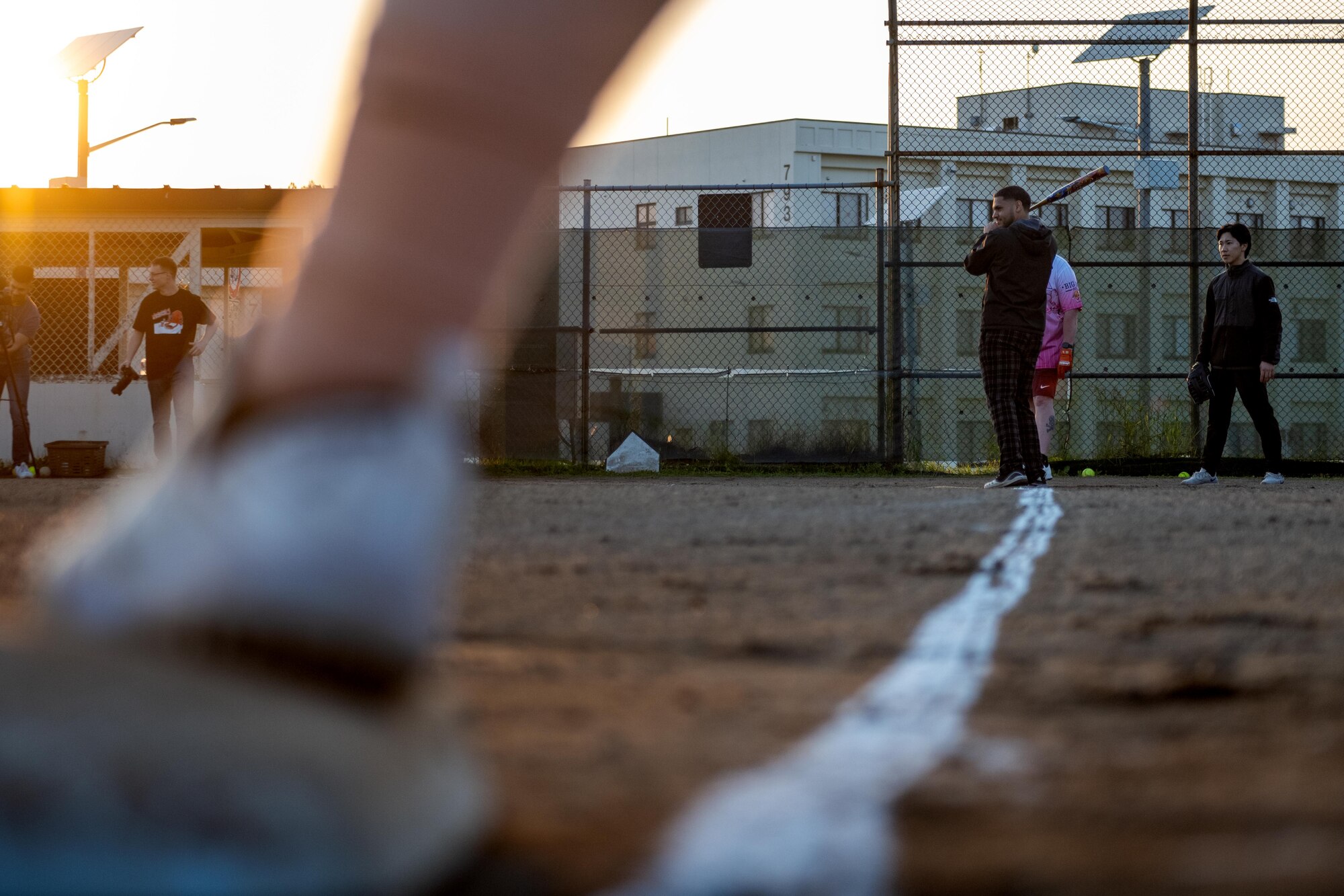 A participant of Sakura Olympics 2025 waits for the pitch in a game of softball.