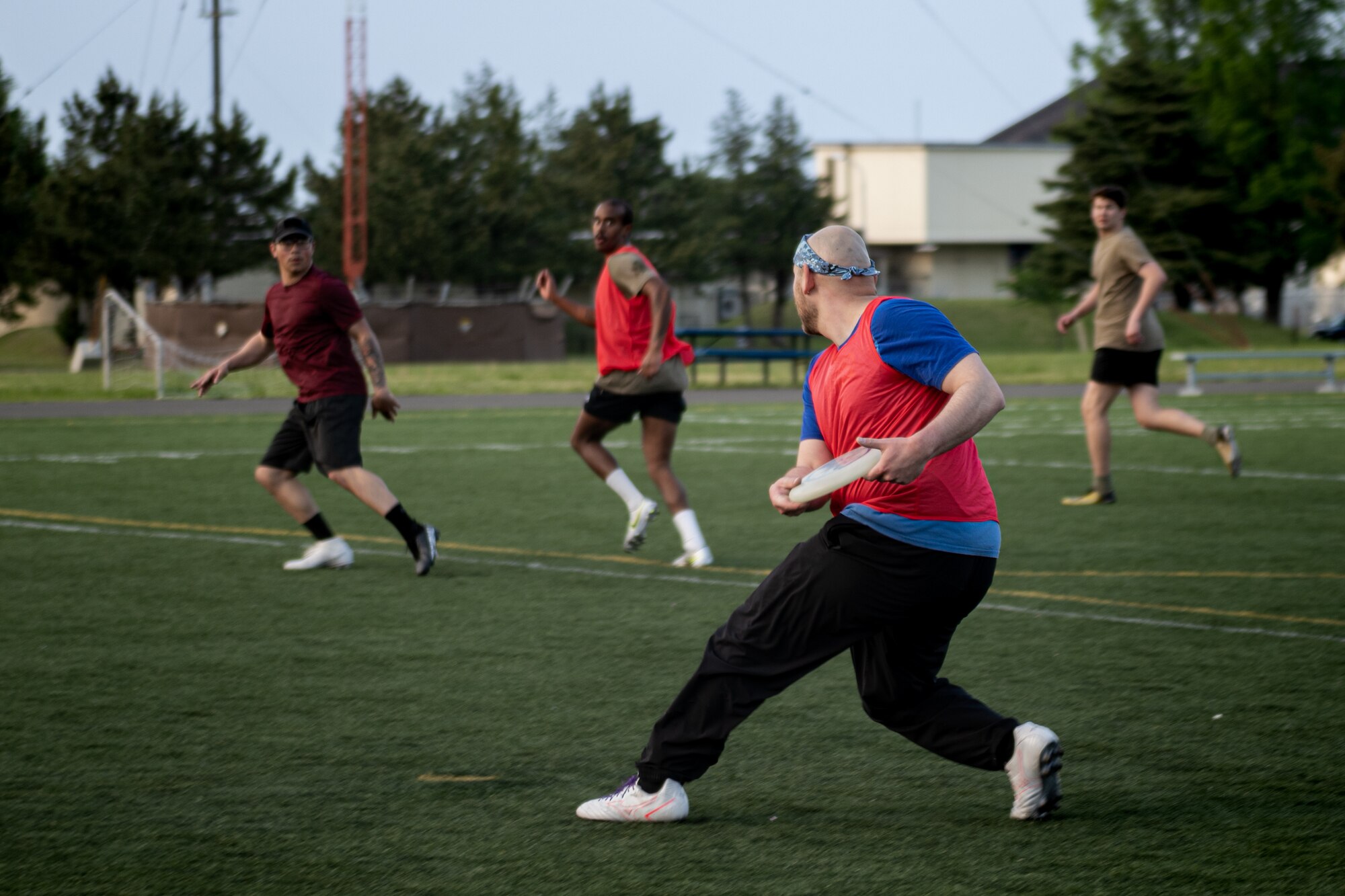 A participant of Sakura Olympics 2025 throws a frisbee to his teammate in a game of ultimate frisbee.