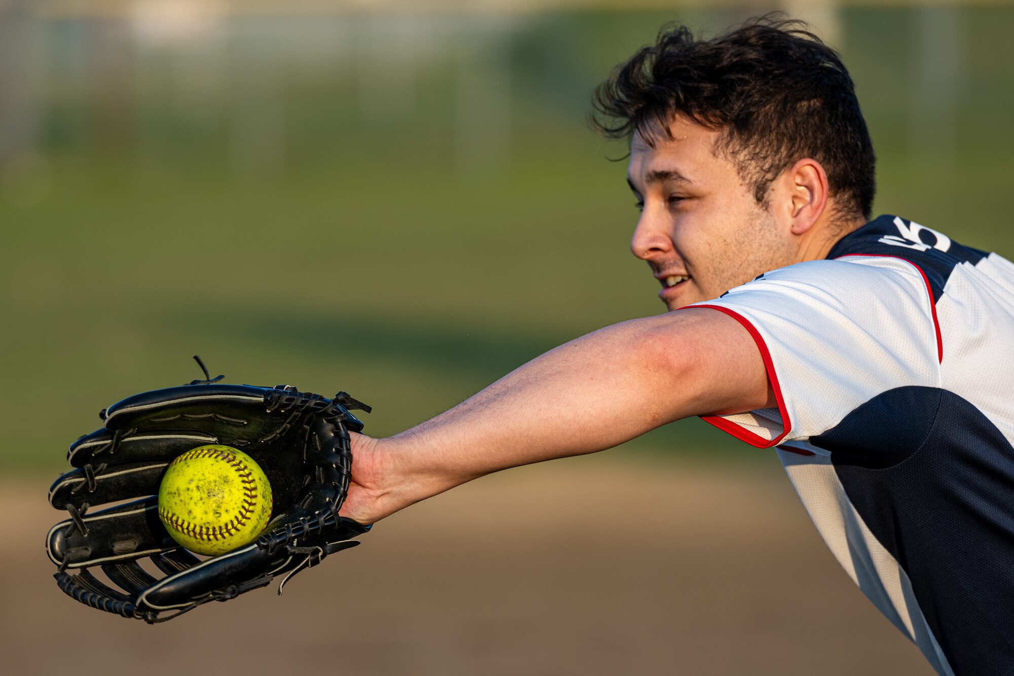 A participant of Sakura Olympics 2025 catches a softball during a game of softball.