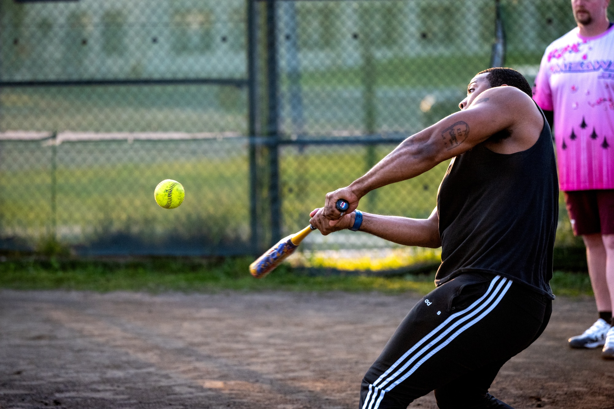 A participant of Sakura Olympics 2025 hits a softball during a game of softball.