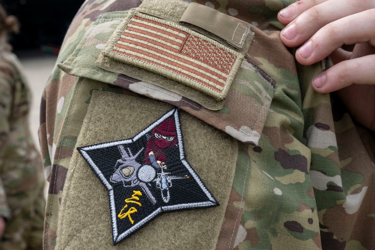 A U.S. Air Force Airman assigned to the 13th Fighter Generation Squadron wears a patch given to him by a member of the Japan Air Self-Defense Force (JASDF) 3rd Air Wing during a refueling interoperability demonstration at Misawa Air Base, Japan, May 30, 2025.