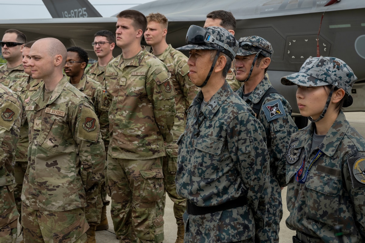Members of the 13th Fighter Generation Squadron and 35th Logistics Readiness Squadron stand beside members of the Japan Air Self-Defense Force 3rd Air Wing during a refueling interoperability demonstration at Misawa Air Base, Japan, May 30, 2025.