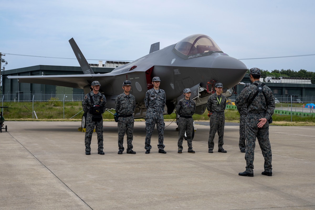 Members of the Japan Air Self-Defense Force (JASDF) 3rd Air Wing stand ready beside a JASDF F-35 Lightning II during a fuels interoperability demonstration at Misawa Air Base, Japan, May 30, 2025.