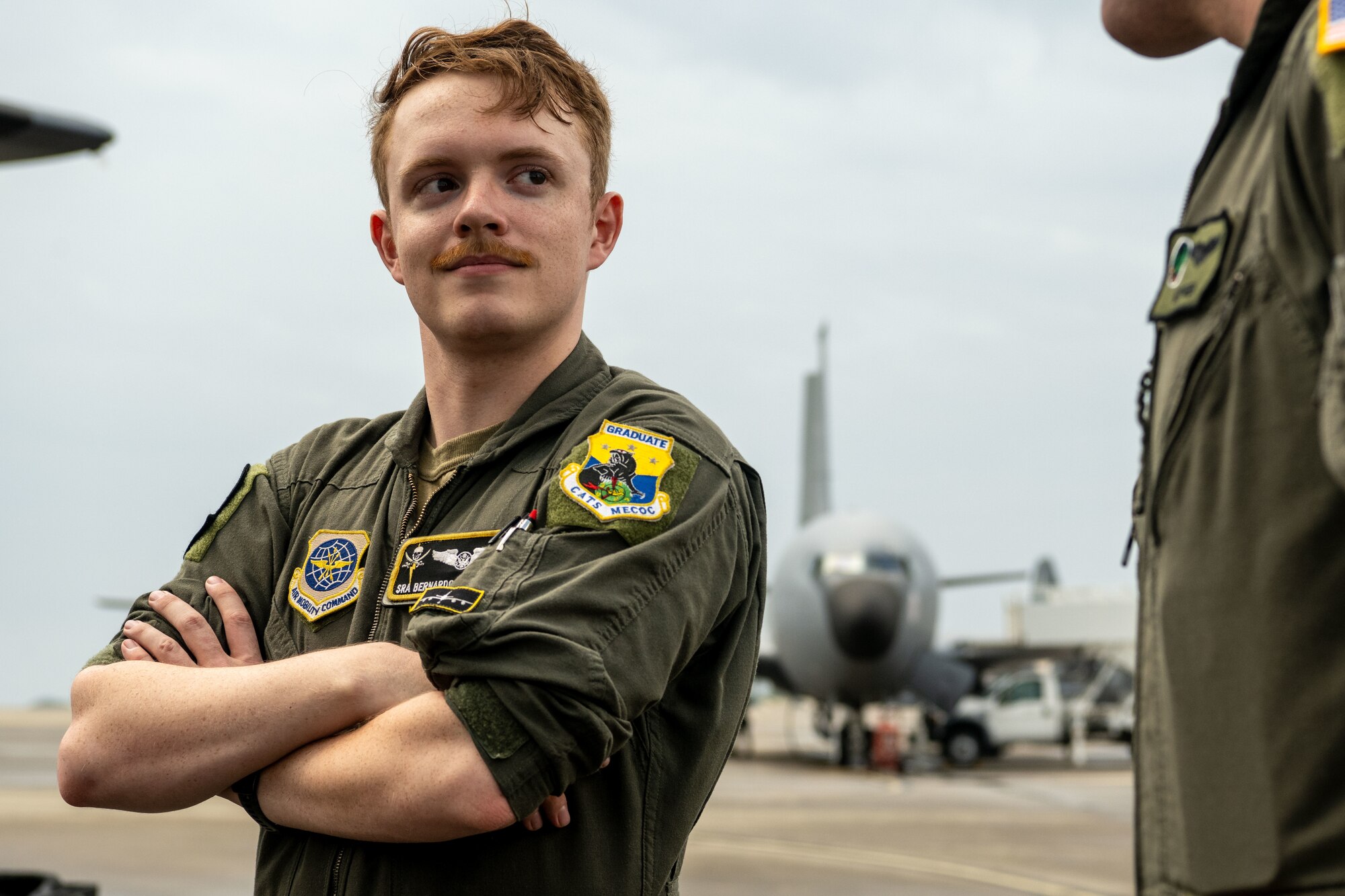 U.S. Air Force Senior Airman Bernardo Valiente, 91st Air Refueling Squadron boom operator, discusses aircraft capabilities with a 1st Special Operations Wing AC-130J Ghostrider pilot during a tour of Hurlburt Field, Florida, May 21, 2025. The tour served as an opportunity for both service members and civic leaders to build connections, share ideas and develop bonds in geographically separated partners. (U.S. Air Force photo by Senior Airman Zachary Foster)