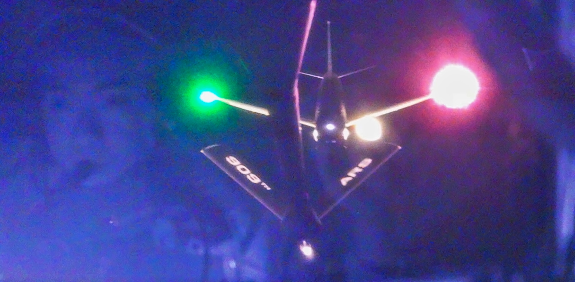 A U.S. Navy aircraft approaches a U.S. Air Force KC-135 Stratotanker.