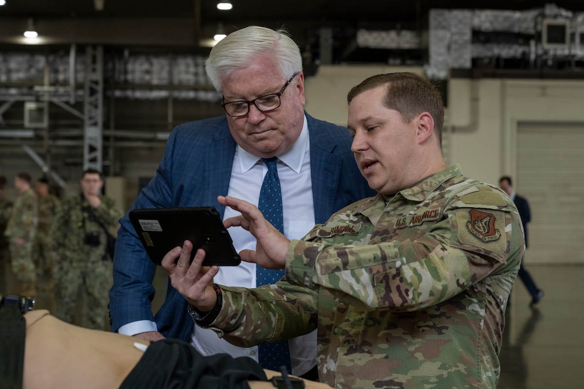 George Glass, right, U.S. Ambassador to Japan, listens as U.S. Air Force Master Sgt. Brett Randall, 13th Fighter Squadron independent duty medical technician, explains the uses of medical equipment at Misawa Air Base, Japan, June 5, 2025.