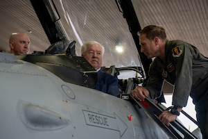 George Glass, center, U.S. Ambassador to Japan, sits in the  cockpit of a U.S. F-16 Fighting Falcon and speaks with U.S. Air Force Col. Paul Davidson, 35th Fighter Wing commander, at Misawa Air Base, Japan, June 5, 2025.
