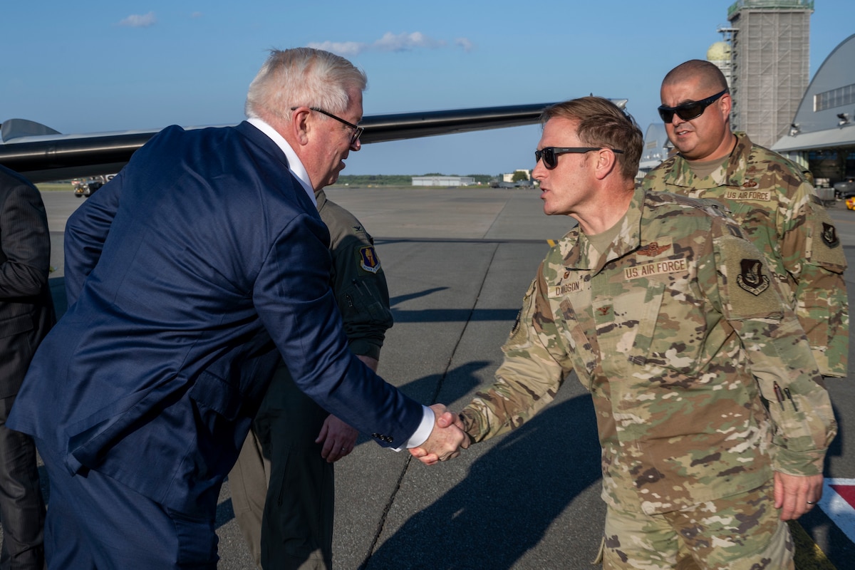 George Glass, left, U.S. Ambassador to Japan, shakes hands with U.S. Air Force Col. Paul Davidson, 35th Fighter Wing commander, at Misawa Air Base, Japan, June 4, 2025.