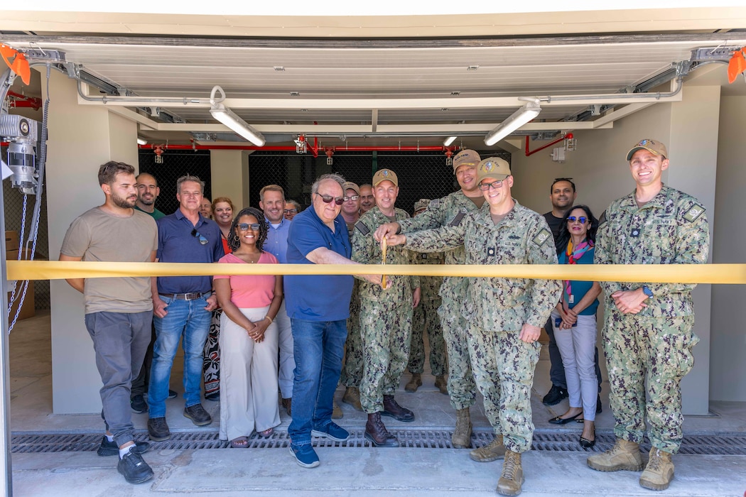 Personnel assigned to Public Works Division Souda Bay and Naval Support Activity (NSA) Souda Bay pose for a group photo during a ribbon cutting ceremony inaugurating the renovation of building 87 onboard NSA Souda Bay, Greece, on June 3, 2025.