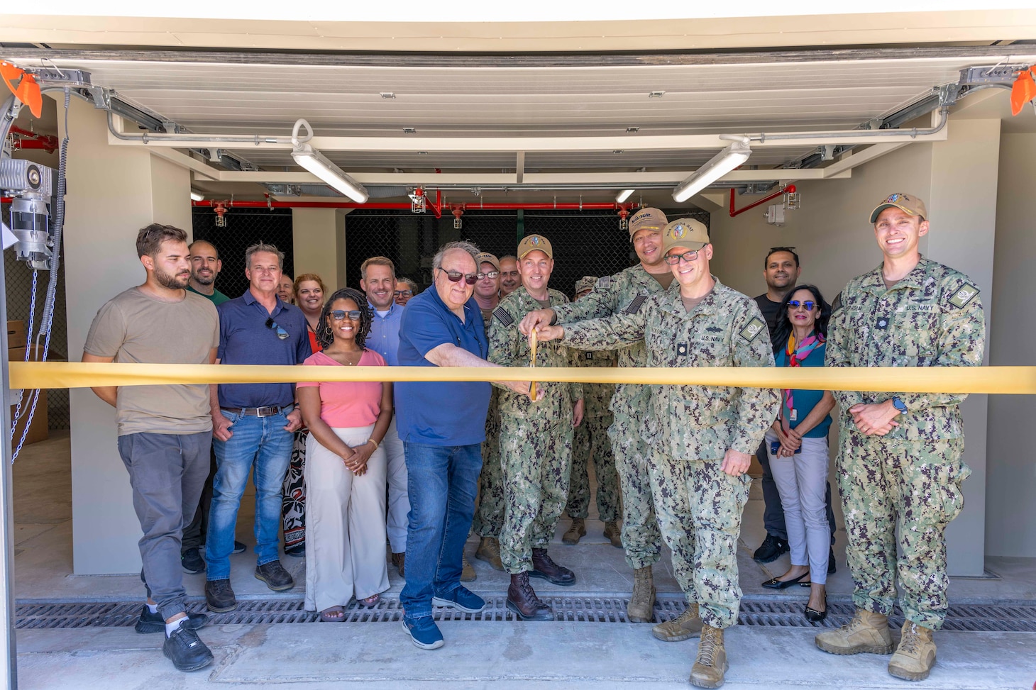 Personnel assigned to Public Works Division Souda Bay and Naval Support Activity (NSA) Souda Bay pose for a group photo during a ribbon cutting ceremony inaugurating the renovation of building 87 onboard NSA Souda Bay, Greece, on June 3, 2025.