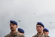 French service members stand in formation as C-130 Hercules aircraft fly overhead during a D-Day commemorative ceremony near Omaha Beach, Normandy, France, June 6, 2025. The event marked the 81st anniversary of the Allied landings and honored the enduring partnership between France and the United States. (U.S. Army photo by Sgt. Tyler Brock)