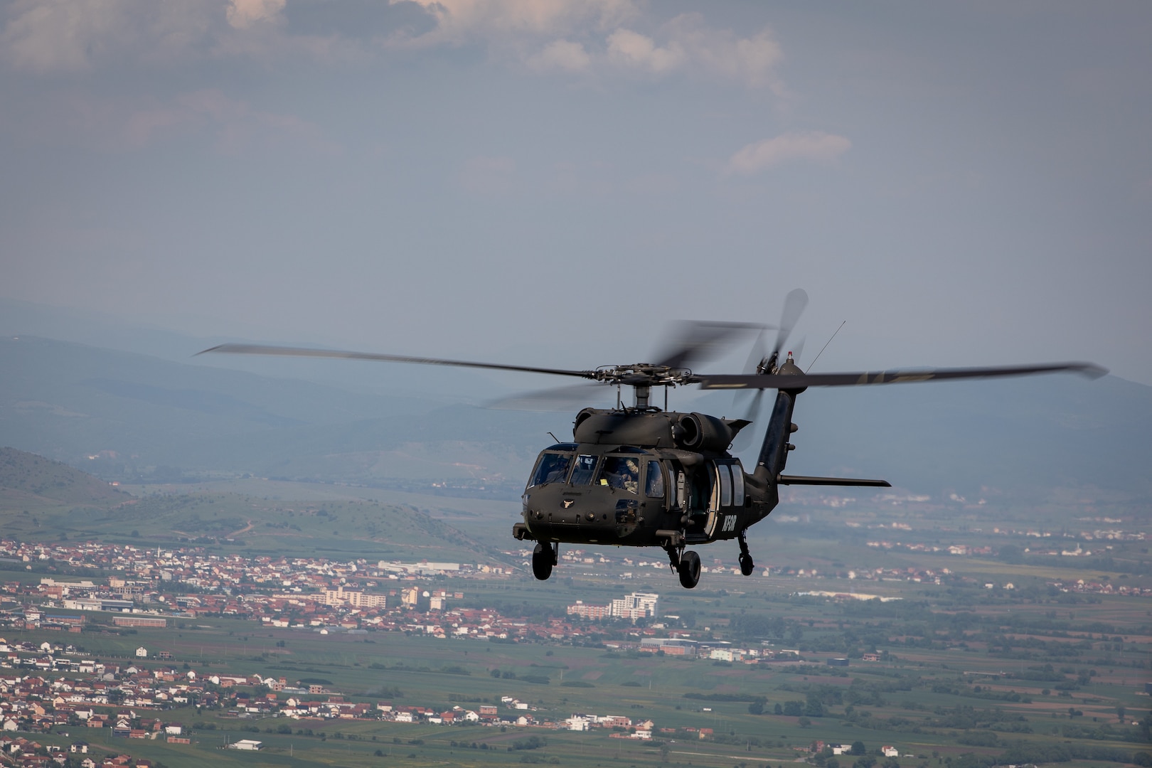 U.S., Hungarian and Swiss aviation forces assigned to the NATO-led Kosovo Force mission, also known as KFOR, conduct an international partner multi-ship familiarization flight, or IPMFF, around Camp Bondsteel, Kosovo, May 12, 2025.