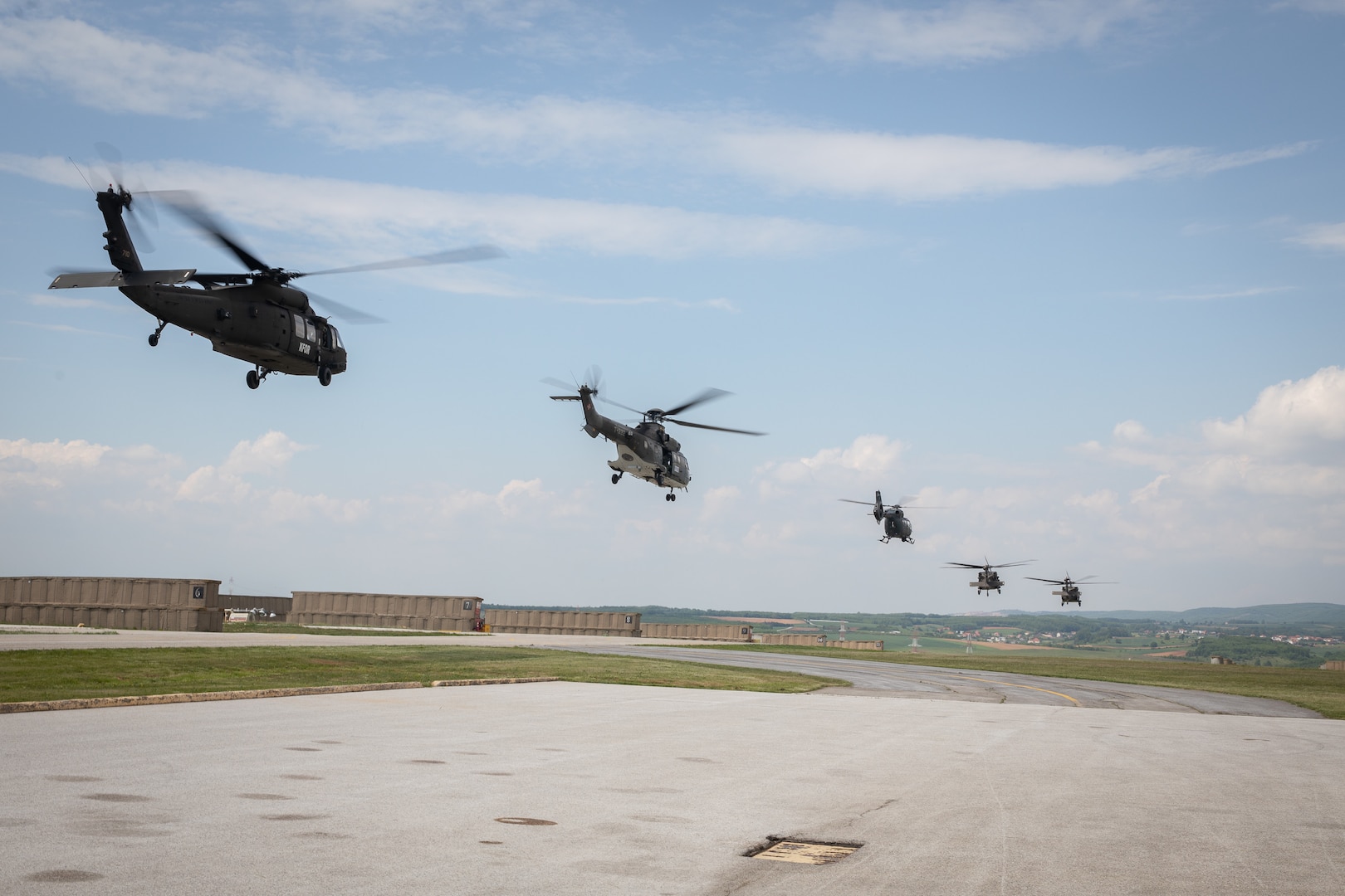 U.S., Hungarian and Swiss aviation forces assigned to the NATO-led Kosovo Force mission, also known as KFOR, conduct an international partner multi-ship familiarization flight, or IPMFF, around Camp Bondsteel, Kosovo, May 12, 2025.