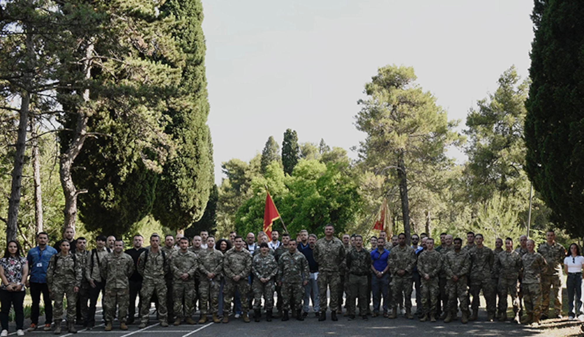 Service members from the Maine National Guard, Vermont National Guard, Armed Forces of Montenegro, and the Army of the Republic of North Macedonia pose for a group photo before beginning a cyber training exercise during Immediate Response 25 at Golubovci Air Base, Montenegro, June 2, 2025.