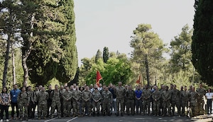 Service members from the Maine National Guard, Vermont National Guard, Armed Forces of Montenegro, and the Army of the Republic of North Macedonia pose for a group photo before beginning a cyber training exercise during Immediate Response 25 at Golubovci Air Base, Montenegro, June 2, 2025.
