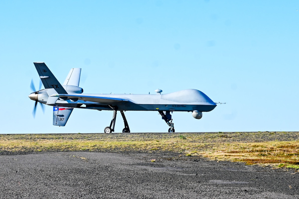An MQ-9 Predator assigned to the Texas Air National Guard’s 147th Attack Wing rests on the flightline at Keflavik Air Base, Iceland, May 19, 2025. The Texas Air National Guard, alongside the Royal Danish Air Force and Icelandic Coast Guard, took part in exercise Formidable Shield 2025. Held from May 1 to May 31, FS25 brought together more than 6,900 personnel from 11 NATO nations for integrated, multi-domain live-fire training. The exercise strengthened NATO’s collective ability to conduct joint air and missile defense operations. (U.S. Air National Guard photo by Senior Airman Asiah Phillips)
