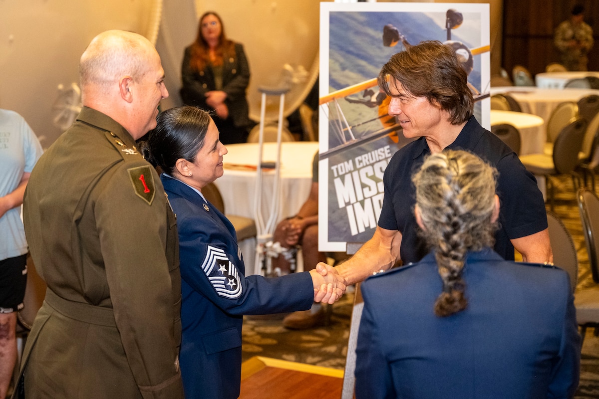 Actor Tom Cruise greets U.S. Air Force Chief Master Sgt. Gilda Alexander, command chief of Joint Base San Antonio and the 502nd Air Base Wing, and U.S. Army Col. Will B. Freds, deputy commander of JBSA and the 502nd Air Base Wing, during a reception with leadership from across JBSA at Hotel Emma, San Antonio, Texas, May 22, 2025. Cruise visited with JB San Antonio leadership and service members to thank them for their sacrifices in support of the mission. (U.S. Air Force photo by Senior Airman Gabriel Jones)