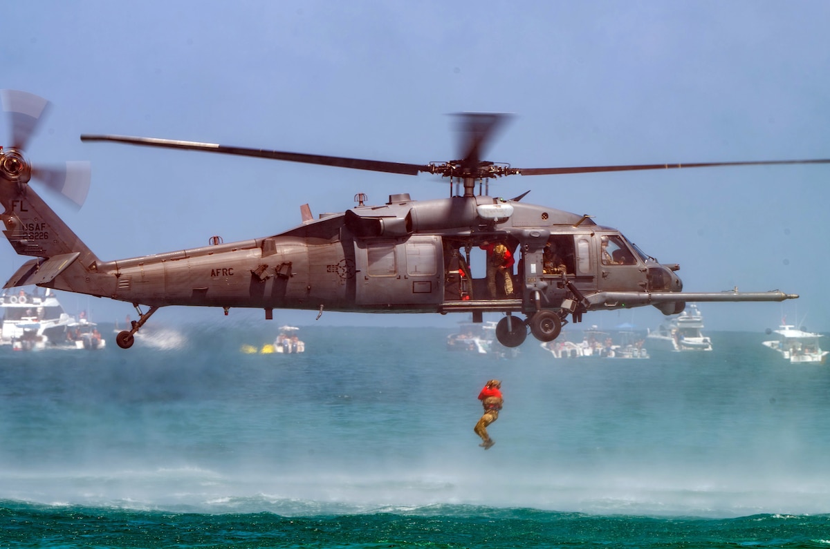 A U.S. Air Force pararescueman assigned to the 308th Rescue Squadron jumps out of an HH-60G Pave Hawk helicopter during a simulated Combat Search and Rescue demonstration at the 2025 Hyundai Air & Sea Show off the coast of Miami Beach, Fla., May 24, 2025. The 920th RQW participates in air shows to demonstrate the wing's ability to carry out its mission to plan, lead and conduct military rescue operations while denying competitors and adversaries exploitation of isolated personnel. (U.S. Air Force photo by Tech. Sgt. Darius Sostre-Miroir)