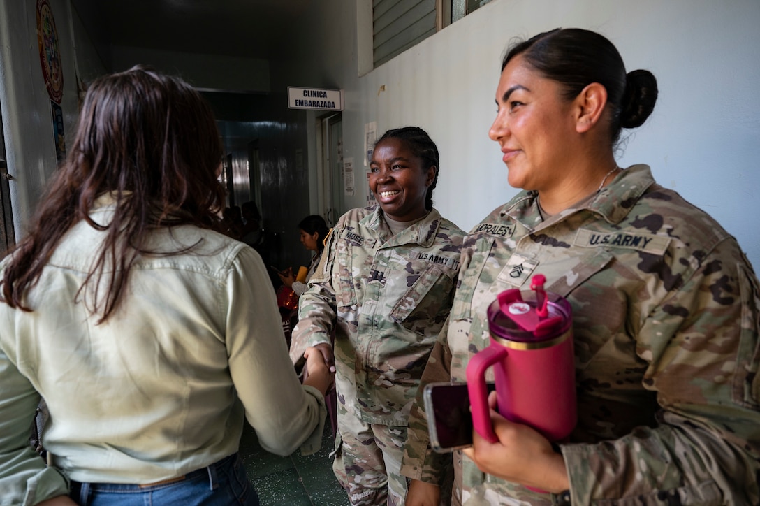 Anna Julia Flores, left, Comayagua governor, shakes U.S. Army Capt. Evelyn Mose’s, Joint Task Force-Bravo public health nurse, hand during a medical mission in Comayagua, Honduras, May 29, 2025. By partnering with local governments and organizations, JTF-Bravo ensures vulnerable communities receive the medical attention they might otherwise lack due to limited healthcare  infrastructure. (U.S. Air Force photo by Staff Sgt. Sadie Colbert)