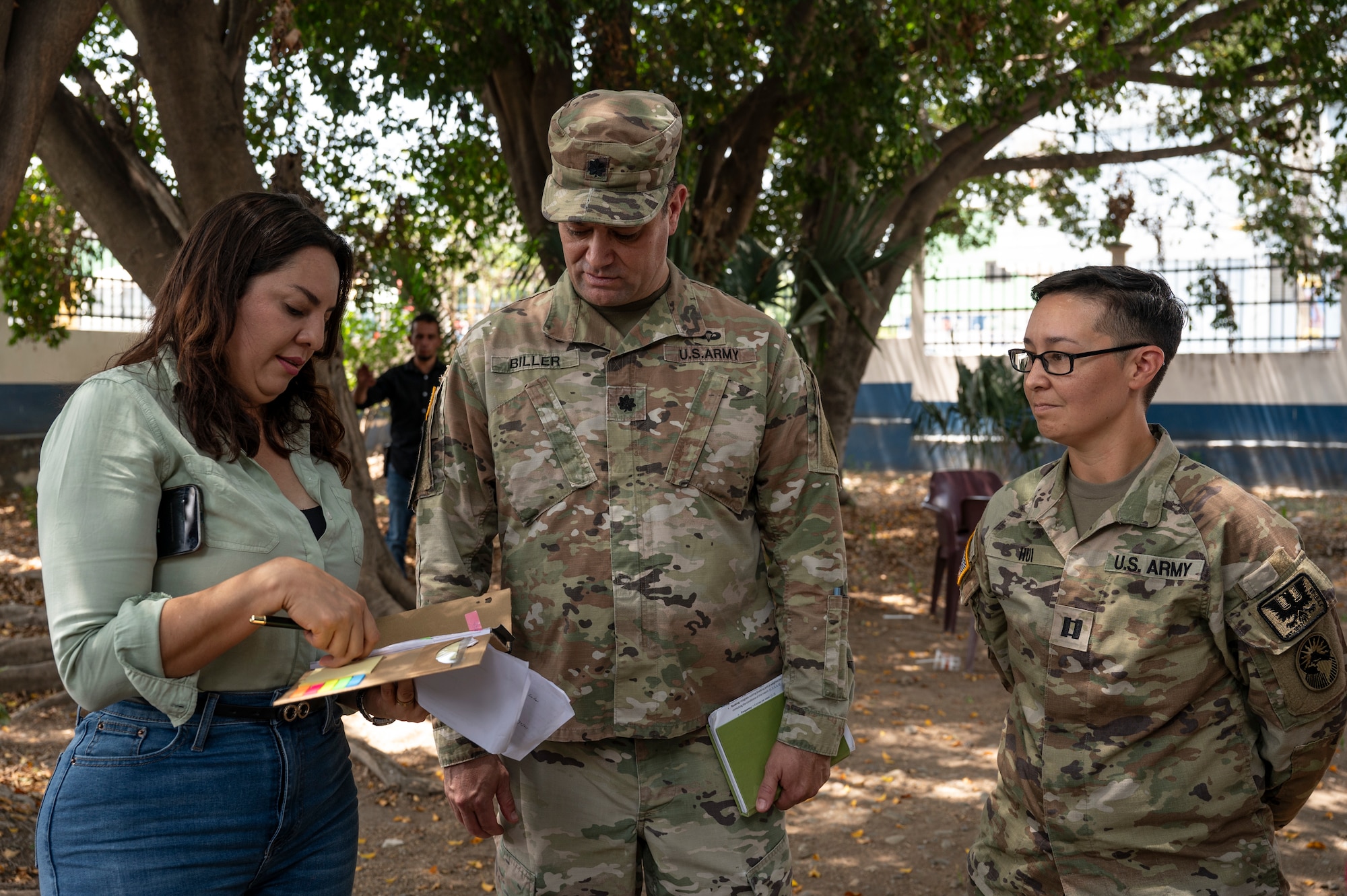Anna Julia Flores, left, Comayagua governor, speaks with U.S. Army Lt. Col. Achim Biller, center, Joint Task Force-Bravo J9, Civil Affairs director, while Capt. Renelle Hui, JTF-Bravo surgeon cell medical planner, listens, during a medical mission in Comayagua, Honduras, May 29, 2025. Since 1992, JTF-Bravo has helped to improve overall public health in Central America, which is integral to long-term regional stability. (U.S. Air Force photo by Staff Sgt. Sadie Colbert)