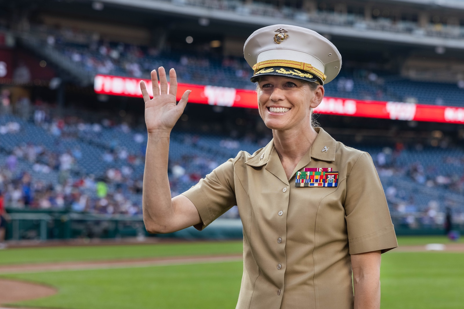 U.S. Marine Corps Col. Jenny Colegate, the commanding officer of Marine Corps Base Quantico, waves to the audience before the baseball game for Marine Day at the Nationals Park, Washington D.C., June 4, 2025. Marine Day is held to demonstrate unique Marine Corps capabilities, develop enduring relationships with our community, and showcase Esprit De Corps. (U.S. Marine Corps photo by Lance Cpl. Harleigh Faulk)