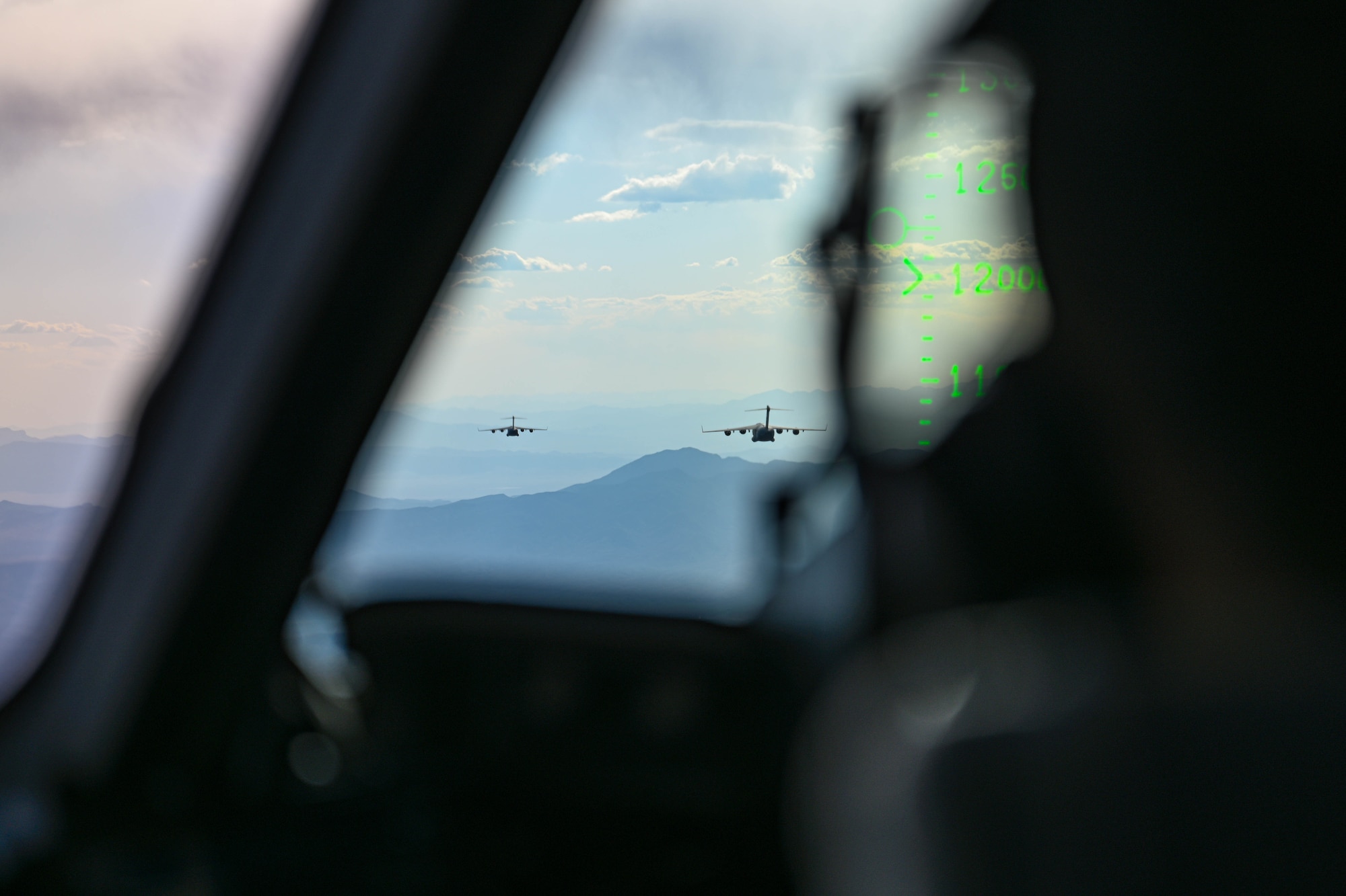 A U.S. Air Force C-17 Globemaster III aircraft assigned to the 97th Air Mobility Wing (AMW) flies in a three-ship formation over Nevada, May 28, 2025. The 97th AMW supported students from the 57th Weapons Squadron; the C-17-focused unit of the U.S. Air Force Weapons School, as they neared completion of their training. (U.S. Air Force photo by Airman 1st Class Jonah Bliss)