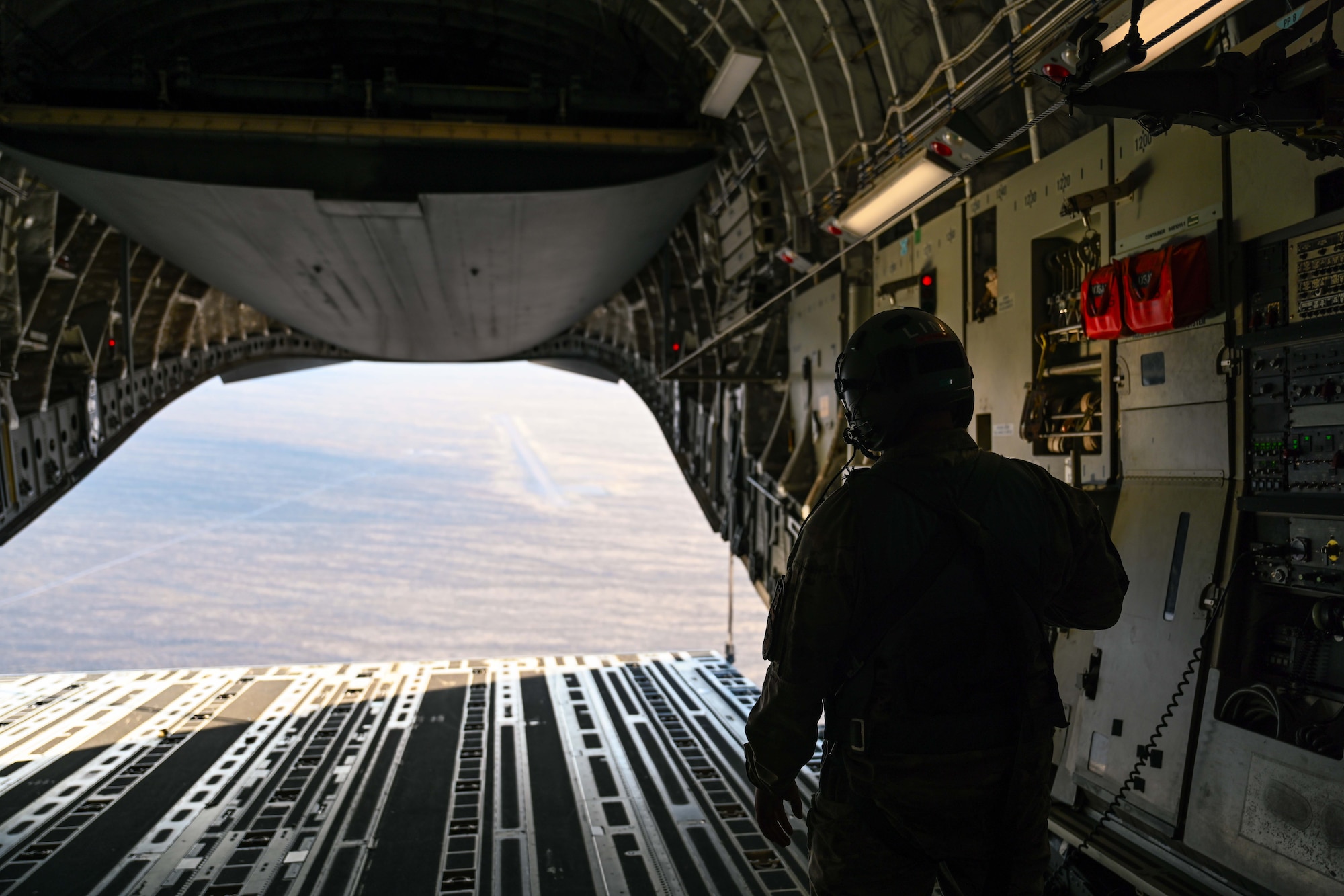 U.S. Air Force Tech. Sgt. Alex Green, 97th Training Squadron evaluator loadmaster and Air Education and Training Command master instructor, closes the ramp of a C-17 Globemaster III aircraft over Nevada, May 28, 2025. Nevada’s vast military airspace and training ranges provide an ideal environment for large-scale joint exercises that test mobility, coordination, and combat readiness. (U.S. Air Force photo by Airman 1st Class Jonah Bliss)