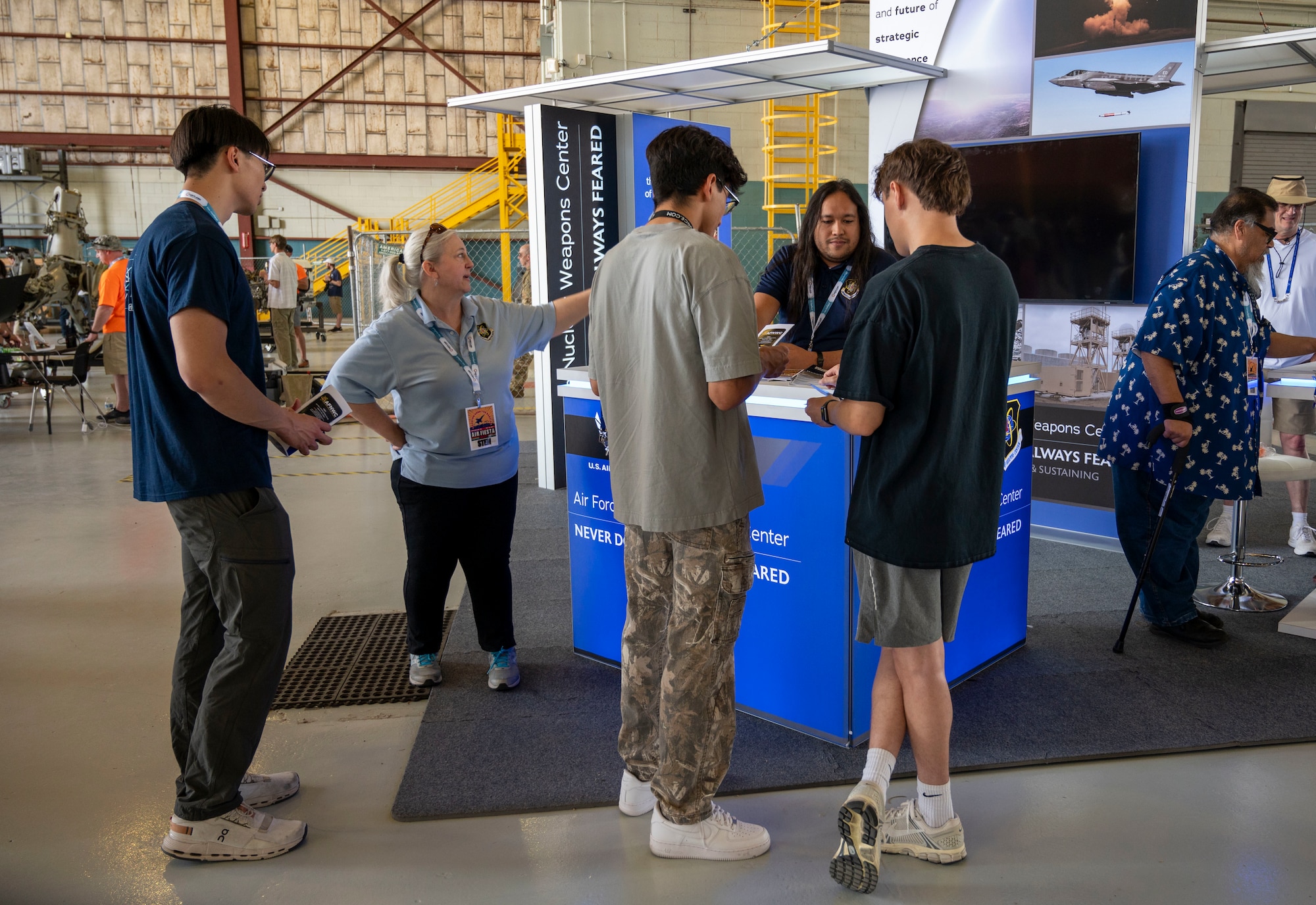 Group of people speak to a man about careers in STEM.