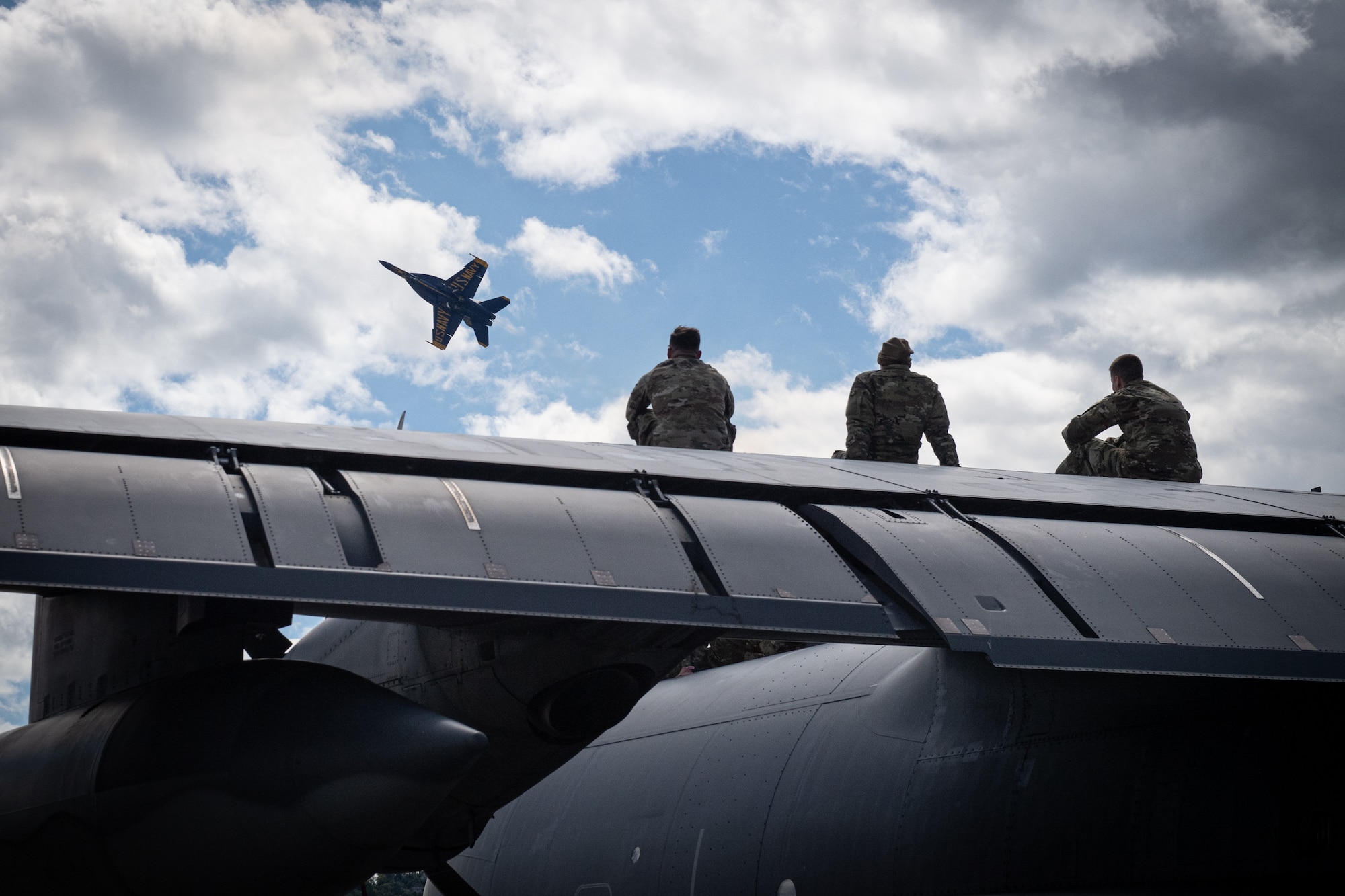 Airmen from the 193rd Special Operations Wing watch the U.S. Navy’s Blue Angels aerial demonstration team perform during an air show at Harrisburg International Airport in Middletown.