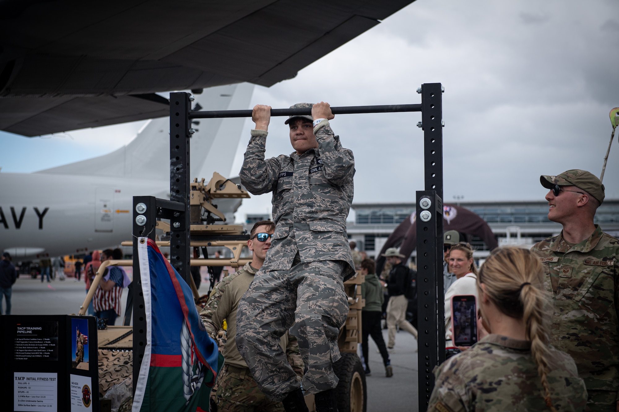 A member of the Civil Air Patrol performs pull-ups as part of recruiting efforts from the 193rd Special Operations Wing during an air show at Harrisburg International Airport.