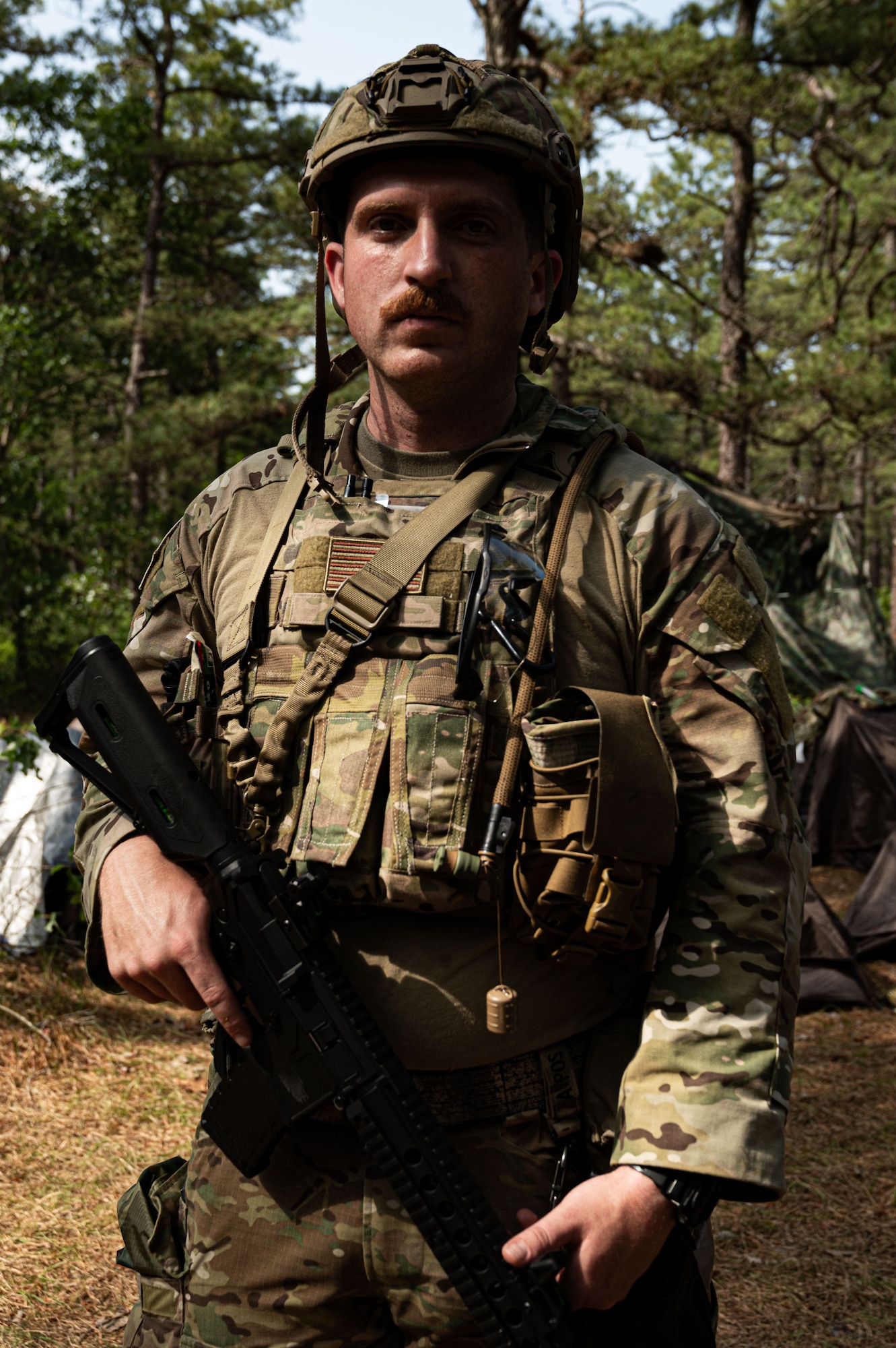 U.S. Air Force Senior Airman Raymond Mocho, 20th Air Support Operations Squadron power production journeyman, poses for a photo at the bivouac.
