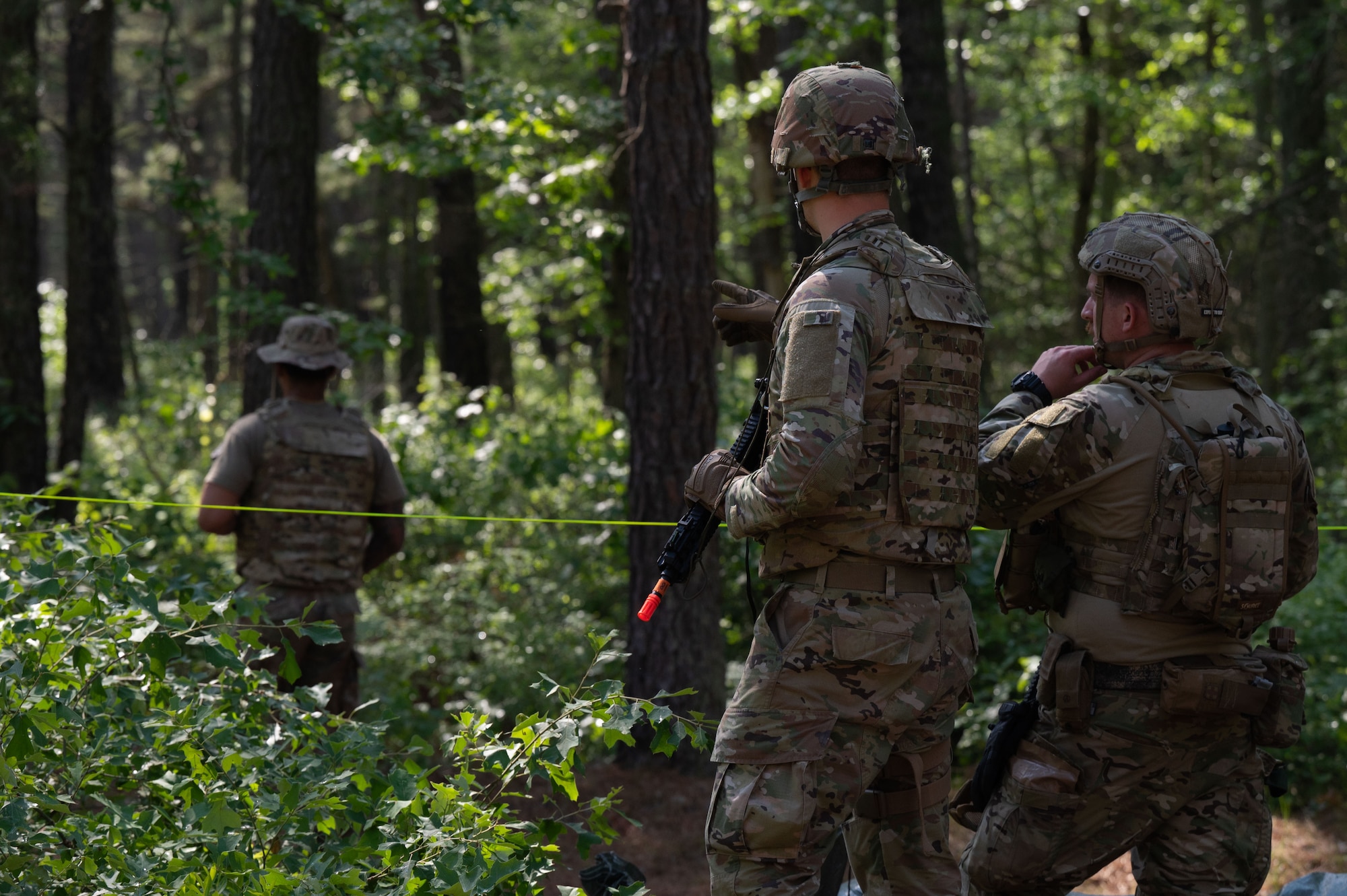 U.S. Air Force Airmen attending the Kish Airman Leadership School, discuss plans to defend their encampment from simulated ground attacks.