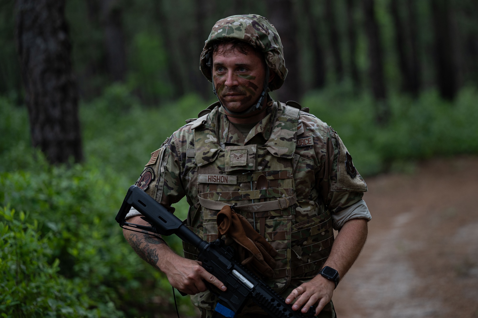 U.S. Air Force Senior Airman Nicholas Hishon, 514th Aeromedical Evacuation Squadron flight medic, walks back to the encampment after a simulated drone and ground attack.