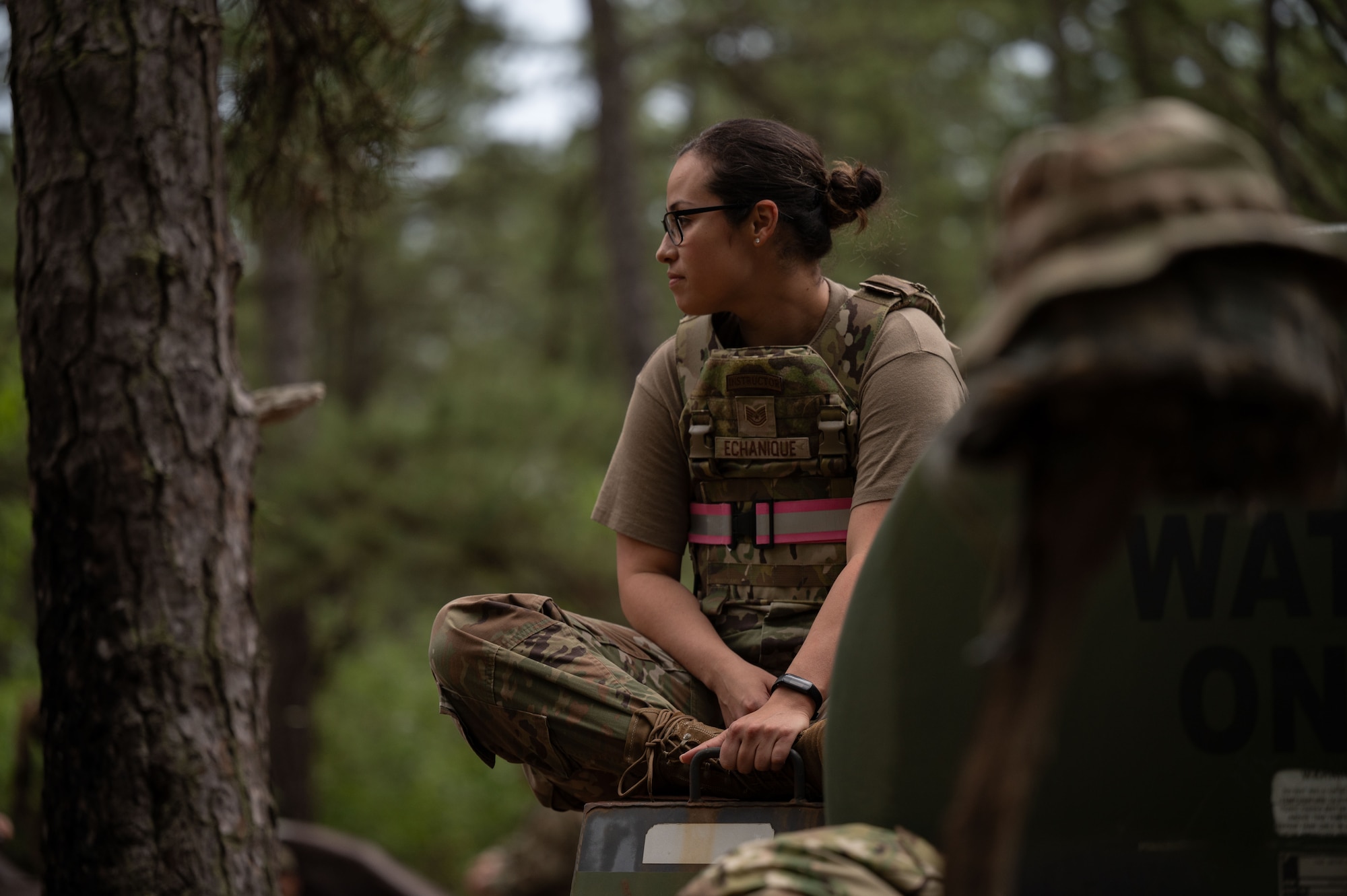 U.S. Air Force Tech. Sgt. Jasmin Echanique, Kish Airman Leadership School instructor, observes students reacting to a simulated attack.
