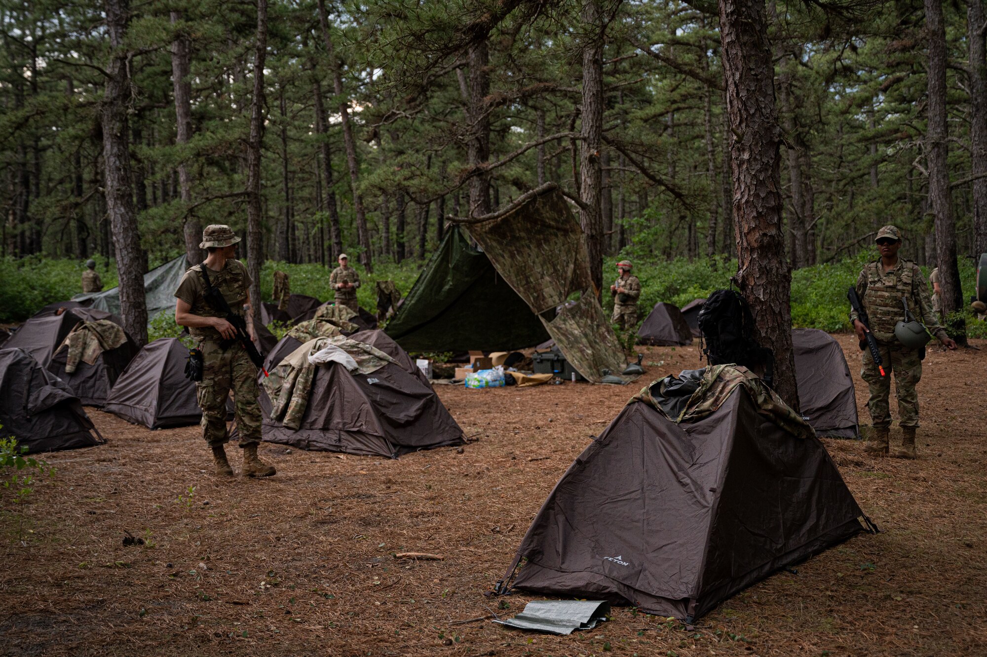 U.S. Air Force Airmen attending the Kish Airman Leadership School, operate out of field tents set up at a bivouac.