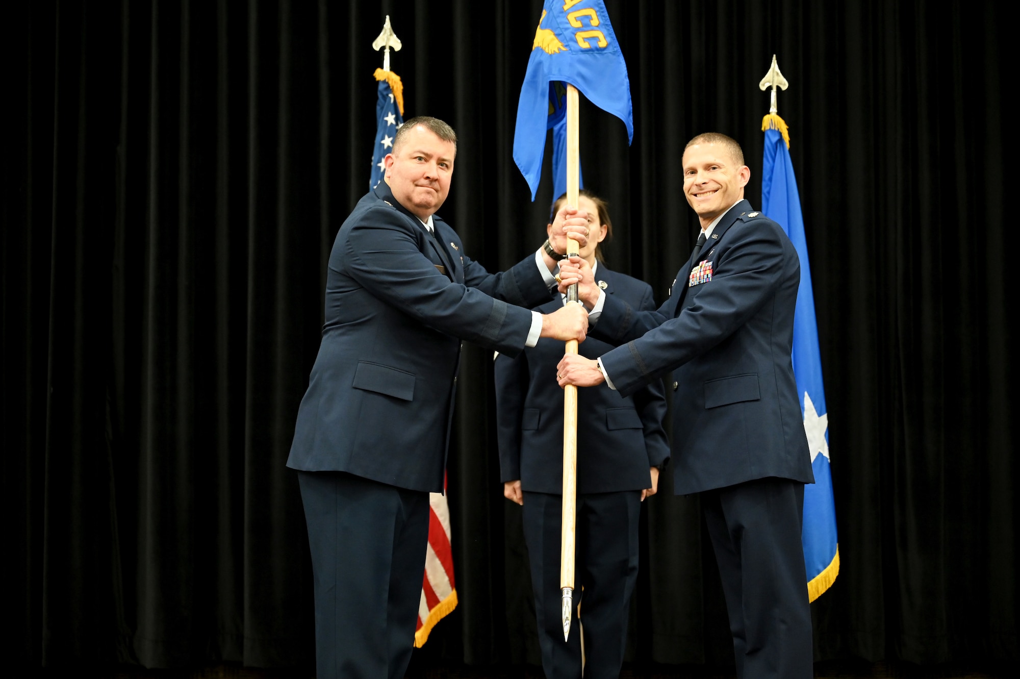 Airmen pose with their new squadron guidon.