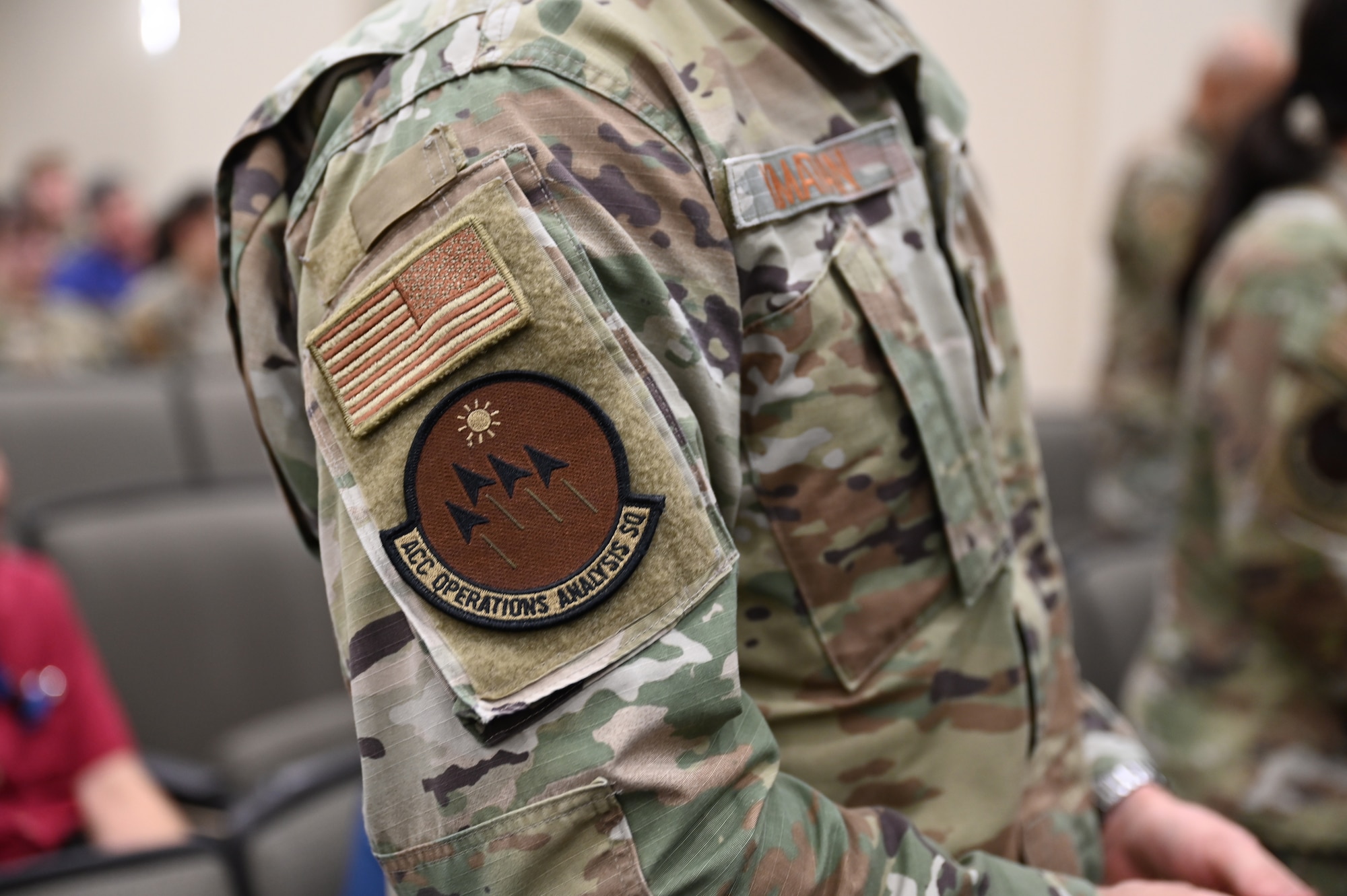An airman changes their squadron patch.