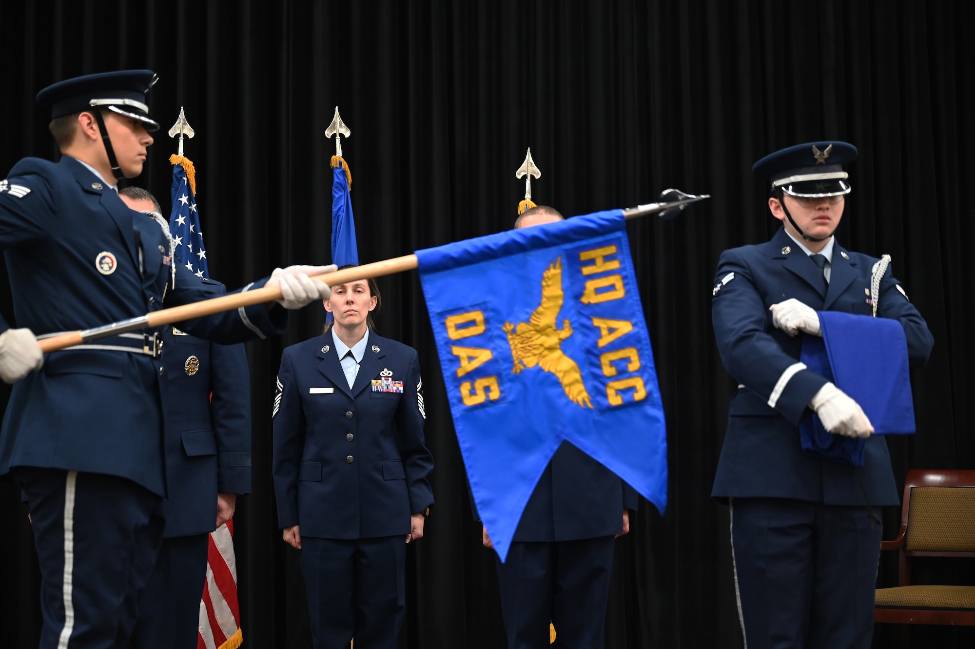 Members unfurl a squadron flag.