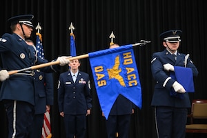Members unfurl a squadron flag.