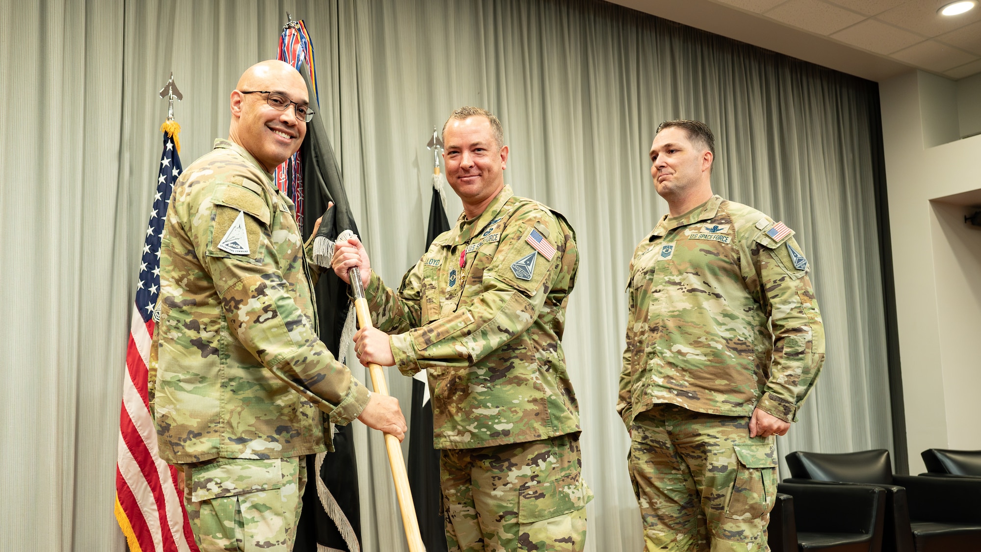 U.S. Space Force Lt. Gen. David N. Miller, commander of Space Operations Command, receives the command colors from Chief Master Sgt. Caleb Lloyd, the outgoing Command Senior Enlisted Leader, as he relinquishes responsibility as SpOC's CSEL during a Change of Responsibility ceremony at Peterson Space Force Base, Colo., June 6, 2025.  The Command Senior Enlisted Leader advises the commander on mission effectiveness, professional development, and military readiness and training of all assigned and attached enlisted space forces enabling the preparation, generation and sustainment of combat-ready intelligence, cyber, space and combat support forces.