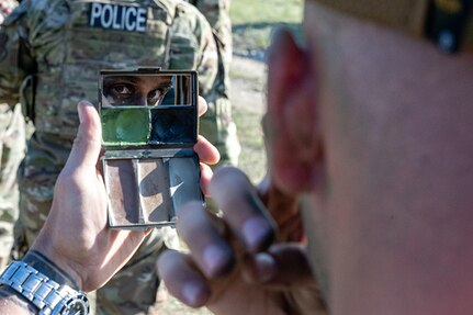 A Security Forces Airman applies face paint in preparation for a field training exercise at  Ft. William Henry Harrison, Helena, Mont., June 3, 2025.