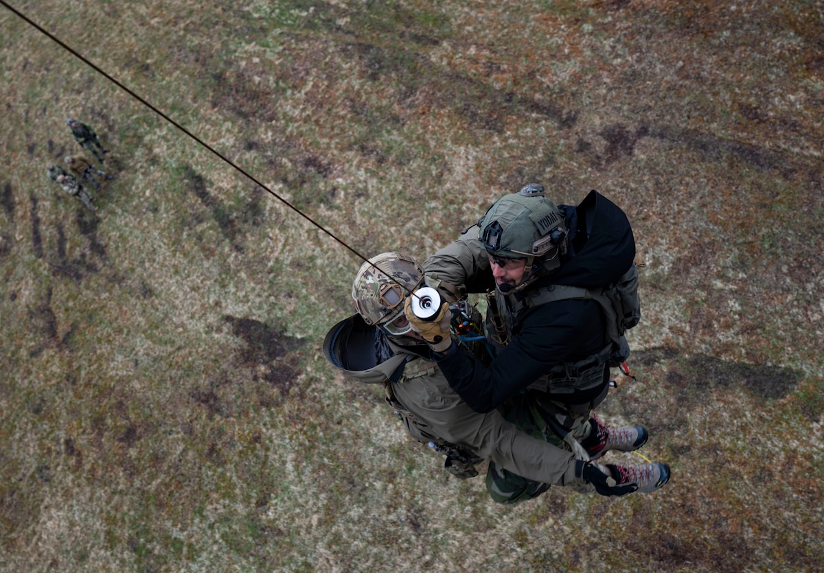rangers being lowered from helicopter