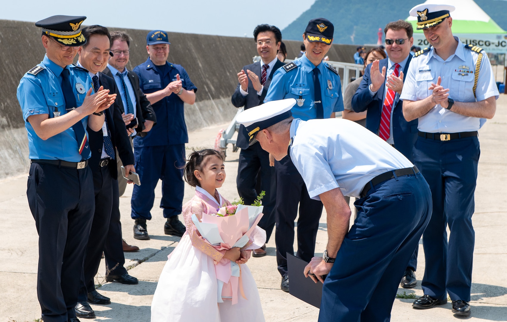 Legend-class U.S. Coast Guard Cutter Stratton (WMSL 752) Commanding Officer Capt. Brian Krautler, center right, greets a welcoming ceremony party upon the ship mooring at the Busan Naval Base in Busan, Republic of Korea, May 29, 2025. Stratton is deployed and assigned to Destroyer Squadron (DESRON) 15, the Navy’s largest DESRON and the U.S. 7th Fleet’s principal surface force. U.S. Coast Guard Cutter Stratton is deployed to the Indo-Pacific to advance relationships with ally and partner nations to build a more secure and prosperous region with unrestricted, lawful access to the maritime commons. (U.S. Coast Guard photo by Petty Officer 3rd Class William Kirk)